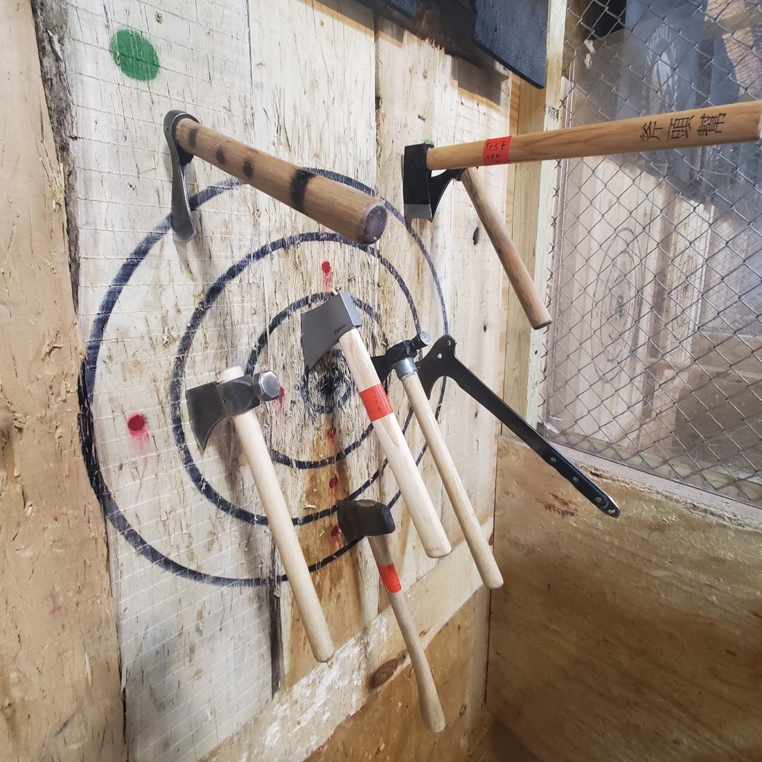 Axes and tomahawks stuck in a spiral target